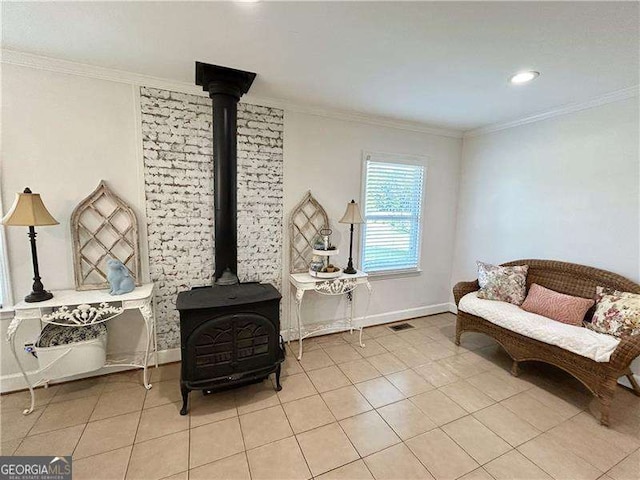 living area featuring light tile patterned floors, a wood stove, and crown molding