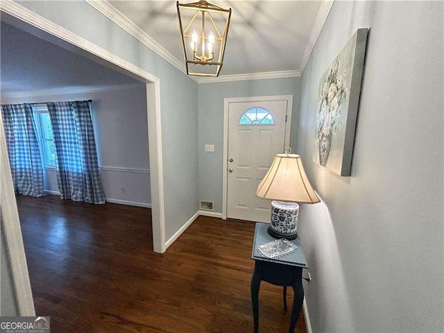 foyer with a notable chandelier, crown molding, and dark hardwood / wood-style floors