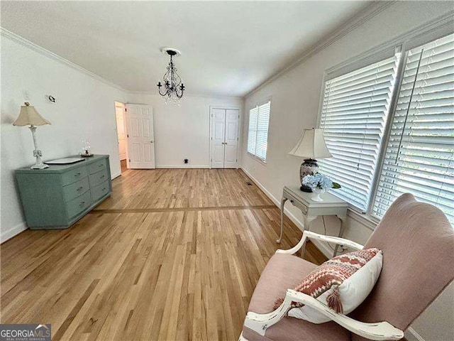 interior space with ornamental molding, light hardwood / wood-style flooring, and a chandelier