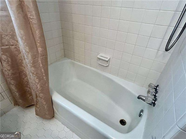 bathroom with tile patterned flooring and shower / bath combo