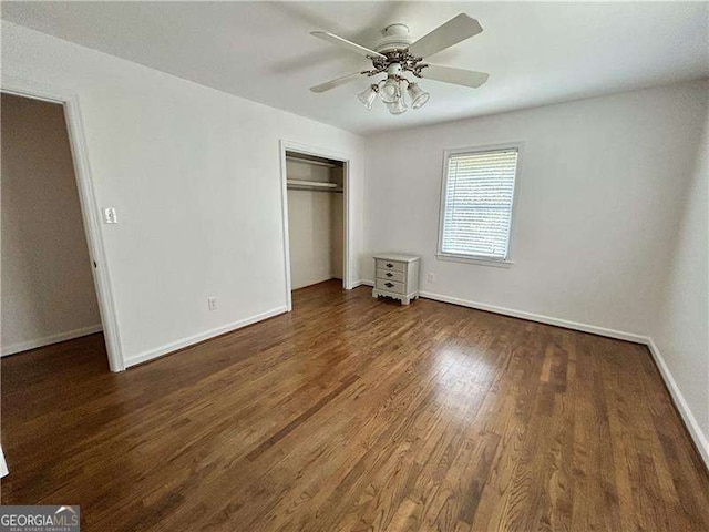 unfurnished bedroom featuring a closet, ceiling fan, and dark wood-type flooring