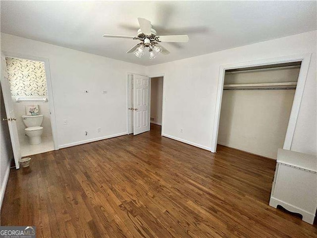 unfurnished bedroom with ceiling fan, dark hardwood / wood-style flooring, a closet, and ensuite bath