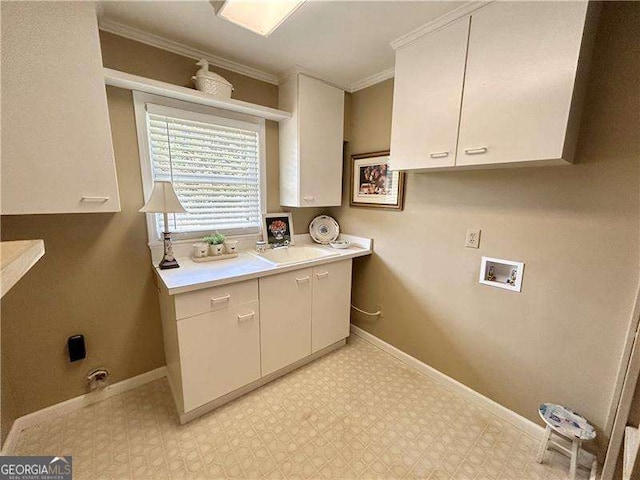 washroom with sink, cabinets, washer hookup, and crown molding