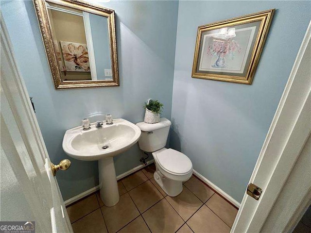 bathroom featuring toilet and tile patterned flooring