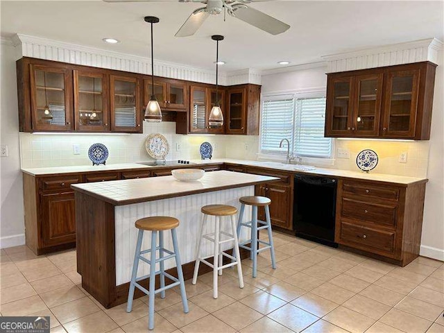 kitchen featuring a center island, light tile patterned floors, black appliances, a kitchen bar, and sink