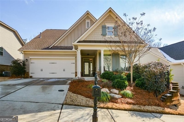 craftsman inspired home featuring a garage and central air condition unit