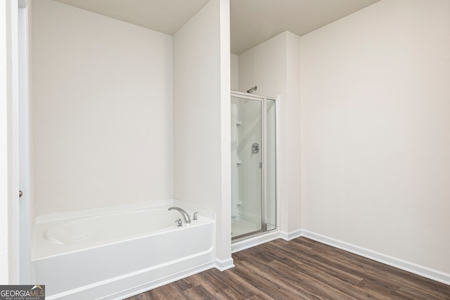 bathroom featuring hardwood / wood-style floors and independent shower and bath