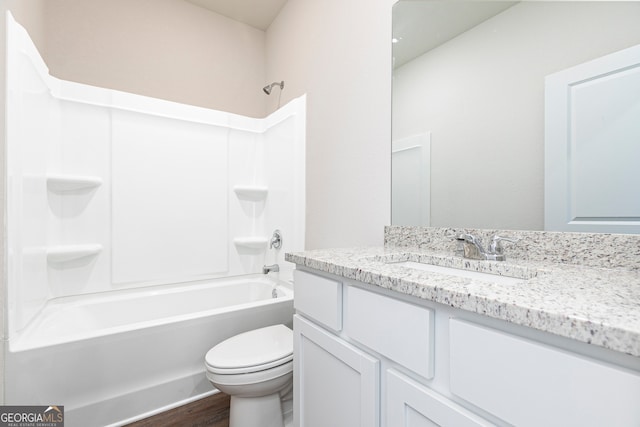 full bathroom featuring toilet, shower / bathing tub combination, hardwood / wood-style flooring, and vanity