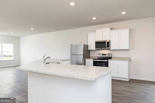 kitchen with dark hardwood / wood-style floors, an island with sink, white cabinetry, appliances with stainless steel finishes, and sink