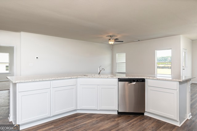 kitchen featuring sink, white cabinetry, stainless steel dishwasher, light stone countertops, and dark hardwood / wood-style floors