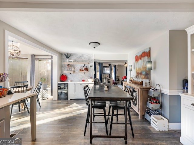 dining space with wine cooler, dark wood-type flooring, and a chandelier