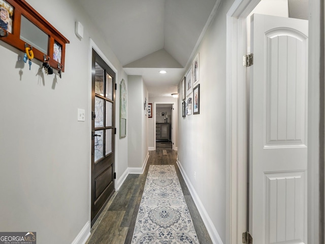 corridor featuring lofted ceiling and dark hardwood / wood-style flooring