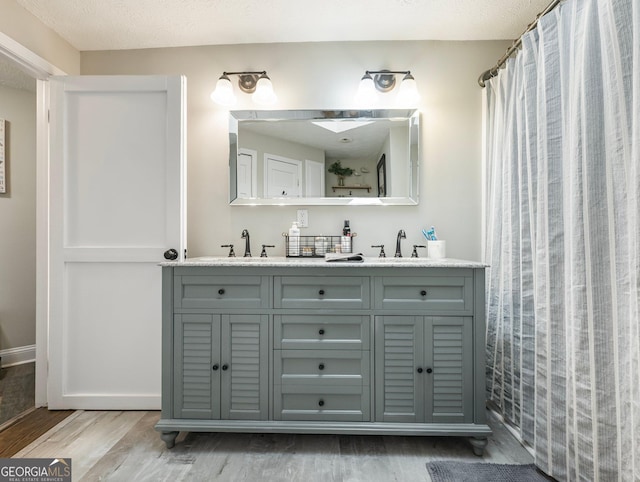 bathroom with hardwood / wood-style flooring and vanity