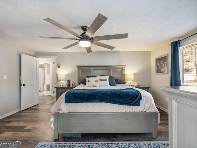 bedroom featuring dark hardwood / wood-style flooring, a textured ceiling, and ceiling fan