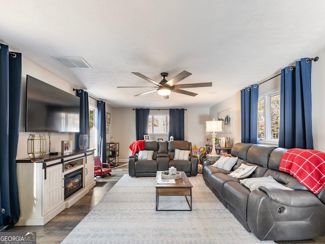 living room with ceiling fan and hardwood / wood-style floors