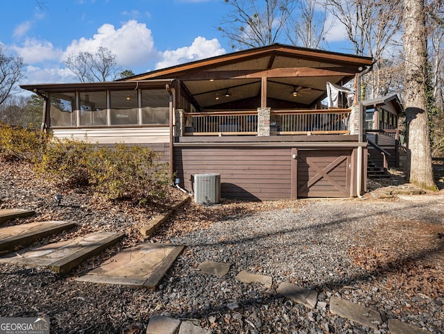 view of side of property featuring central AC unit, a sunroom, ceiling fan, and a deck