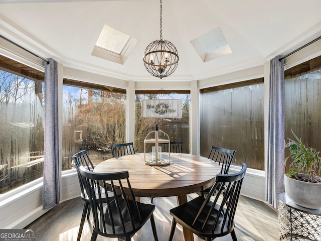 sunroom with a skylight and a chandelier