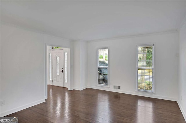 unfurnished room with crown molding and dark hardwood / wood-style floors