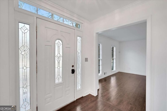 foyer with a healthy amount of sunlight, dark wood-type flooring, and crown molding