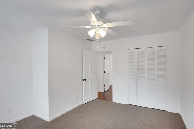 unfurnished bedroom with a closet, ceiling fan, and carpet floors