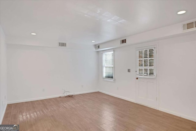 spare room with light hardwood / wood-style floors