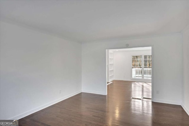 spare room featuring dark hardwood / wood-style floors