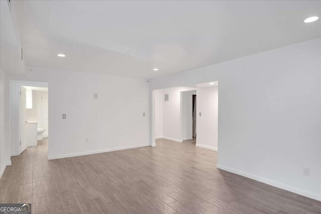 spare room with wood-type flooring