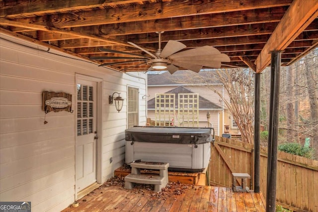 view of patio featuring a deck, ceiling fan, and a hot tub