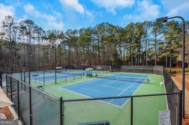 view of tennis court featuring basketball hoop