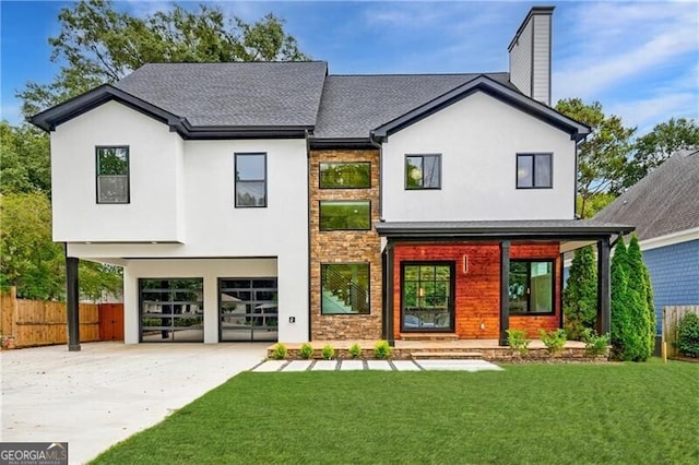 back of property featuring a lawn and a garage