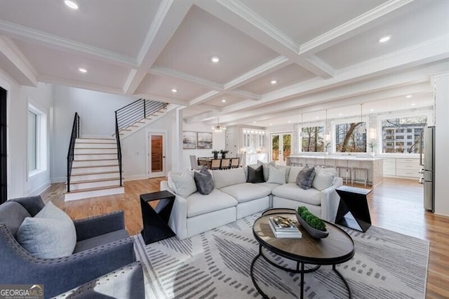 living room with beam ceiling, ornamental molding, light hardwood / wood-style flooring, and coffered ceiling