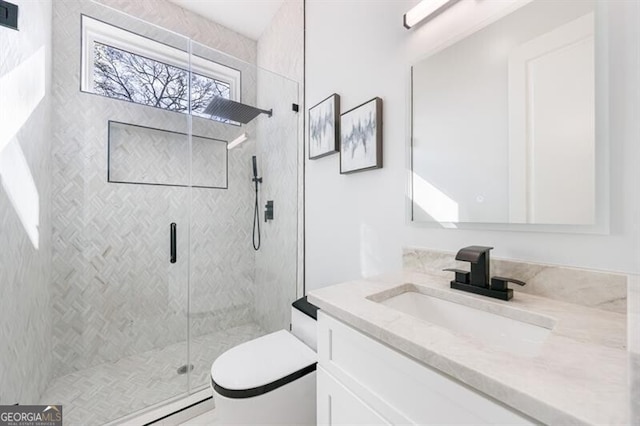 bathroom with a shower with door and vanity