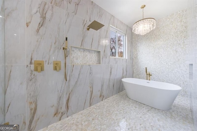 bathroom with tile walls, an inviting chandelier, and plus walk in shower