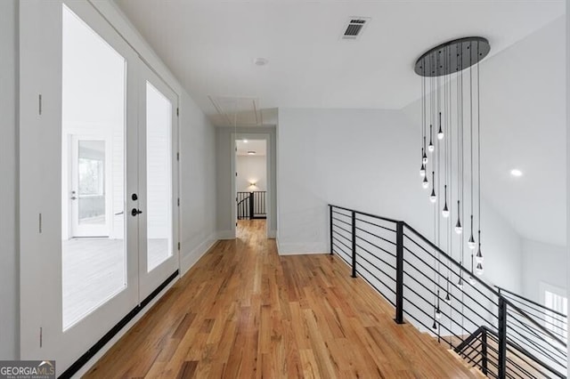 hall featuring french doors and light hardwood / wood-style flooring