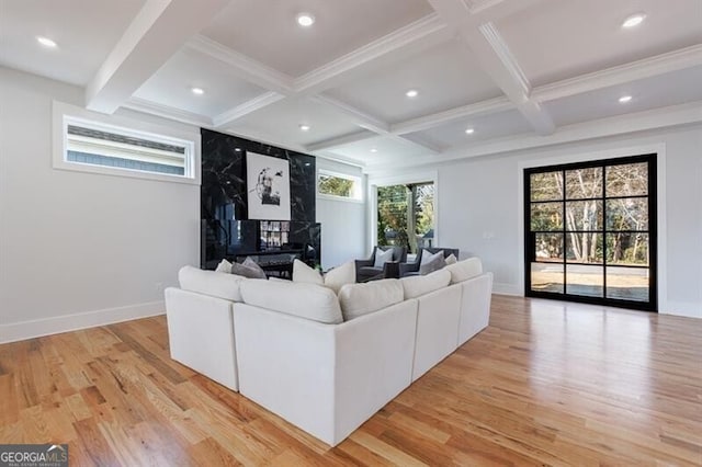 living room with beam ceiling, light wood-type flooring, and coffered ceiling