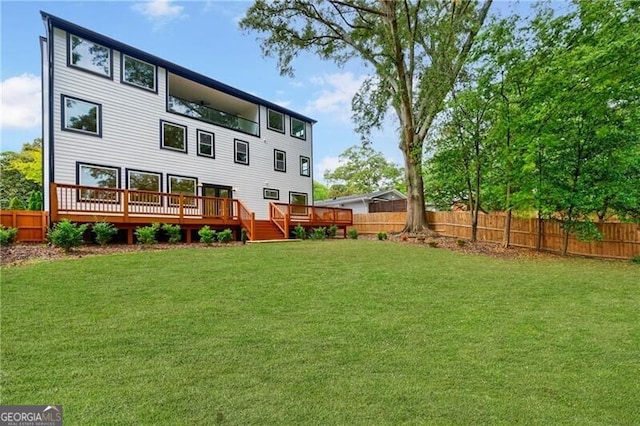 back of house with a lawn and a wooden deck