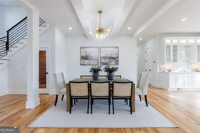 dining area with a notable chandelier and light wood-type flooring