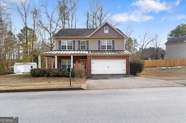 view of front of house with a storage shed, covered porch, and a garage