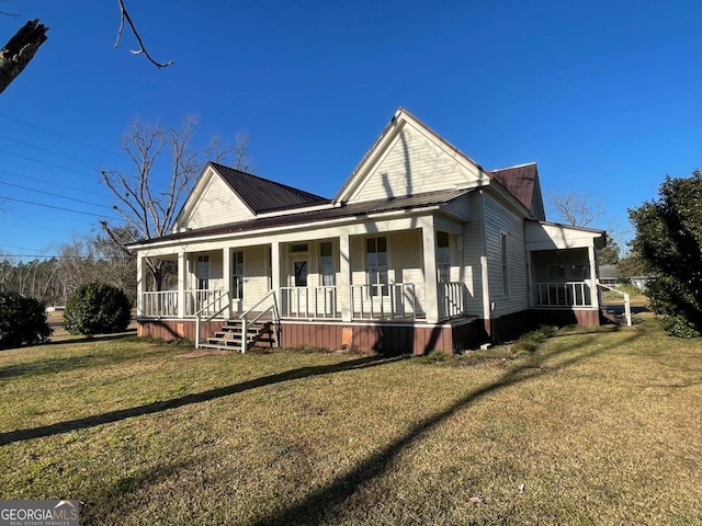 view of front of home with covered porch and a front lawn