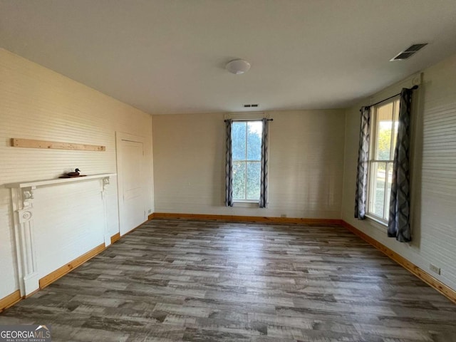 empty room with dark hardwood / wood-style floors