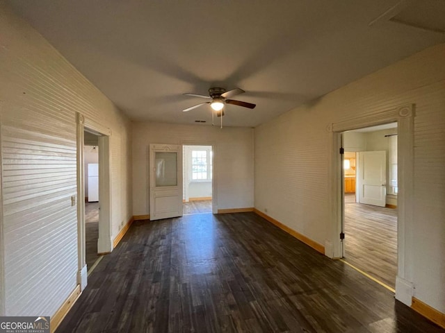 unfurnished room featuring ceiling fan and dark hardwood / wood-style floors