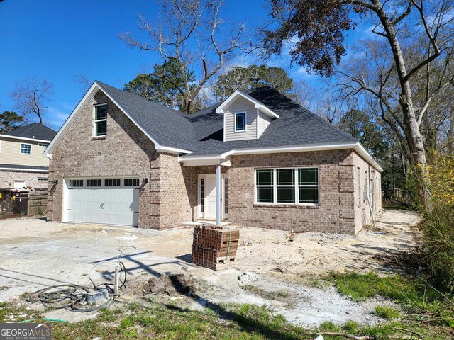 rear view of house with a garage