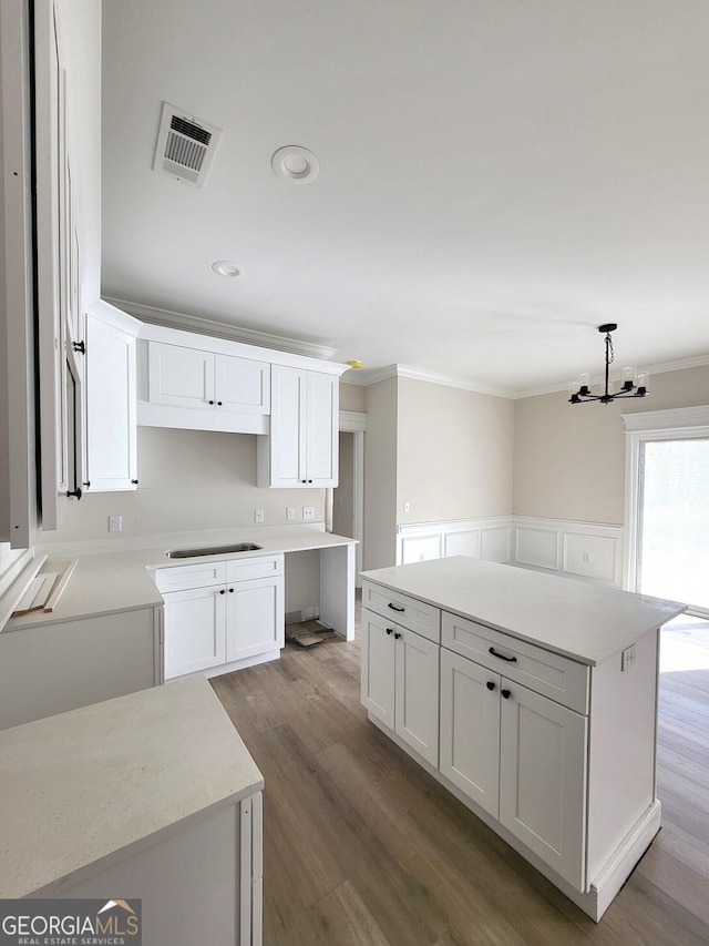 kitchen with visible vents, white cabinets, wood finished floors, light countertops, and recessed lighting