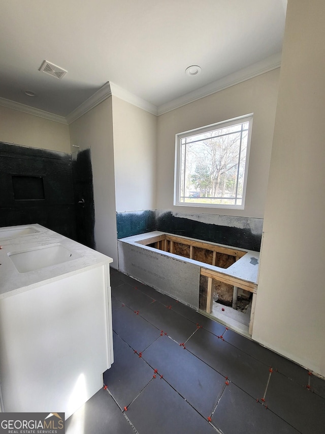 bathroom with ornamental molding and visible vents