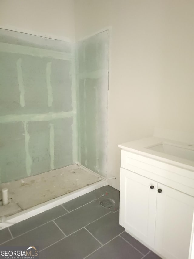 bathroom with tile patterned flooring and vanity