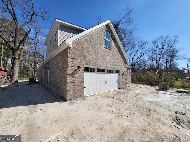 view of home's exterior with central AC and brick siding