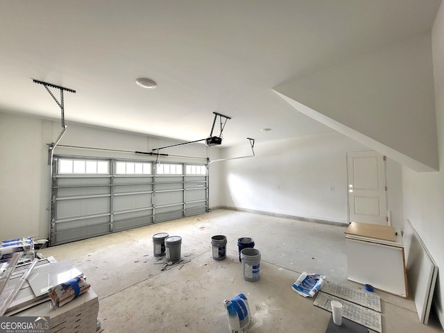 garage with baseboards and a garage door opener