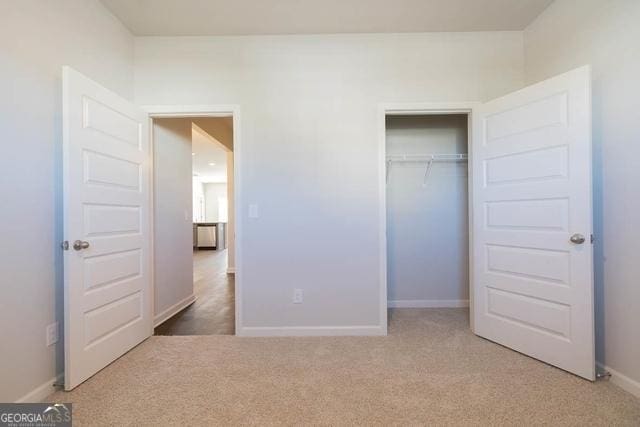 unfurnished bedroom with a closet and carpet