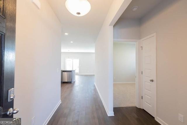 hallway with dark hardwood / wood-style flooring