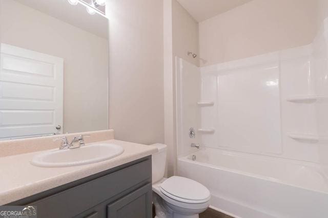 full bathroom with toilet, vanity, and bathing tub / shower combination